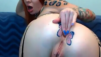 Webcam Show Featuring A Heavily Tattooed Redhead With Butterfly Designs