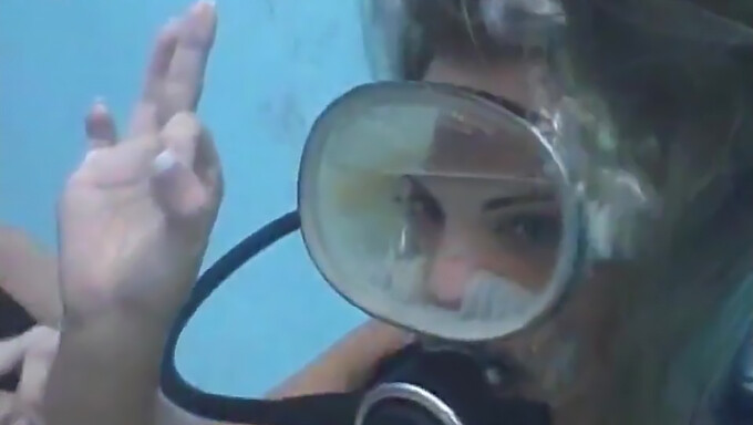 A scuba diver receives a facial finish inside her mask